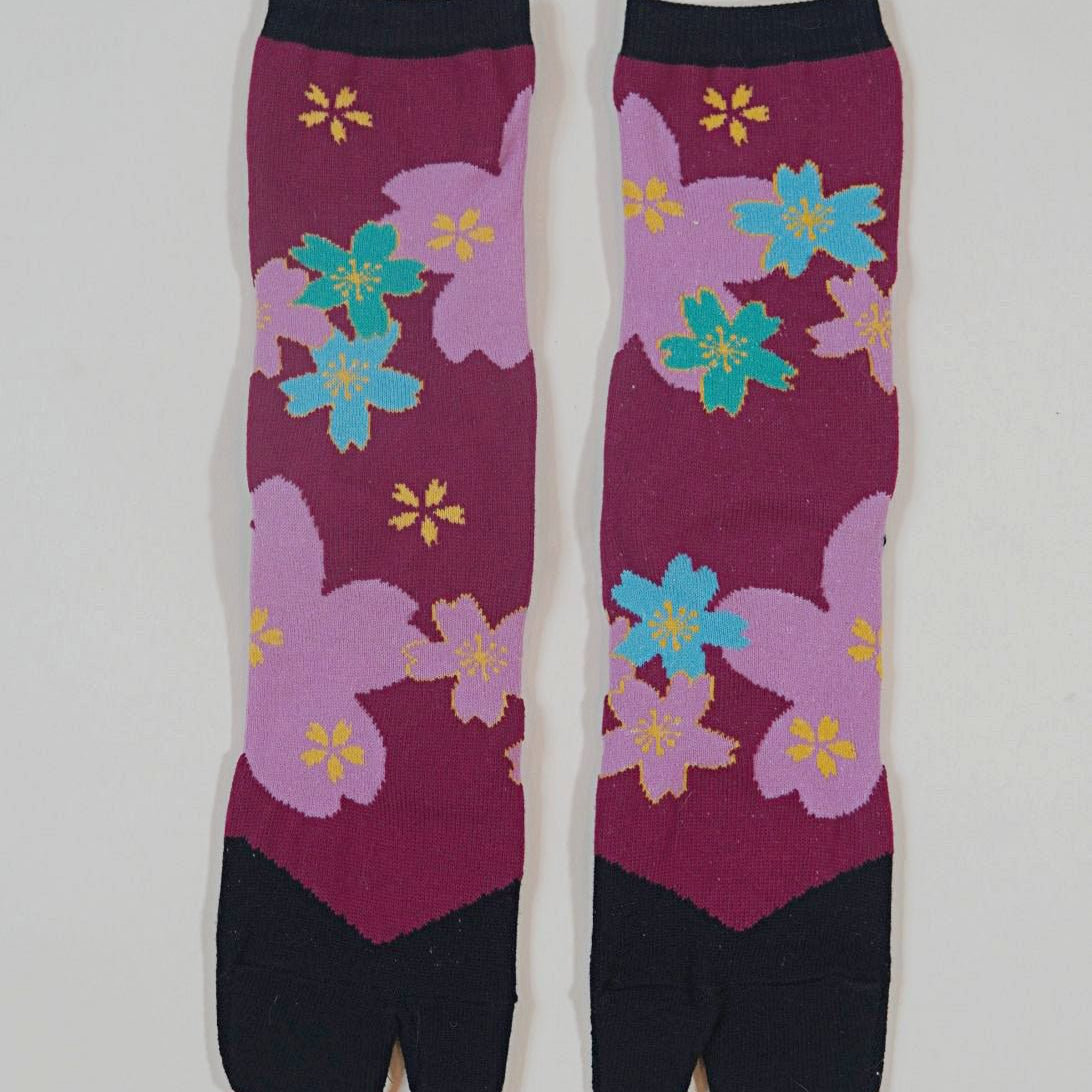 Pair of socks with floral pattern on a light gray background