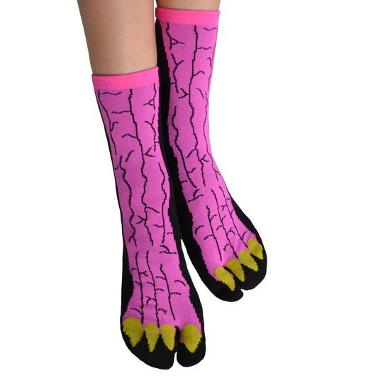 A pair of pink Tabi sandals socks with black lines and yellow accents designed to resemble animal claws.