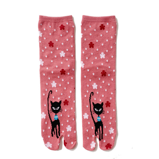 A pair of pink tabi socks with black cats and cherry blossoms design